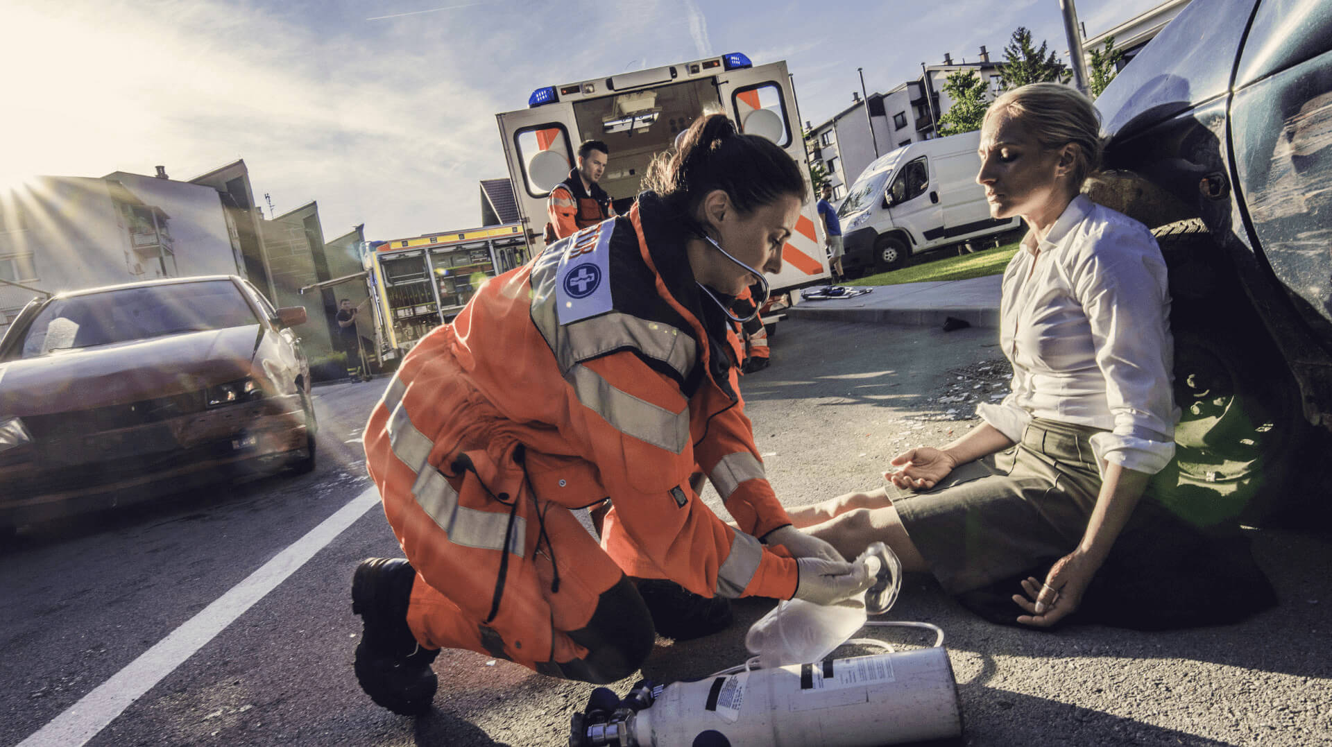 EMS attending to car accident victim