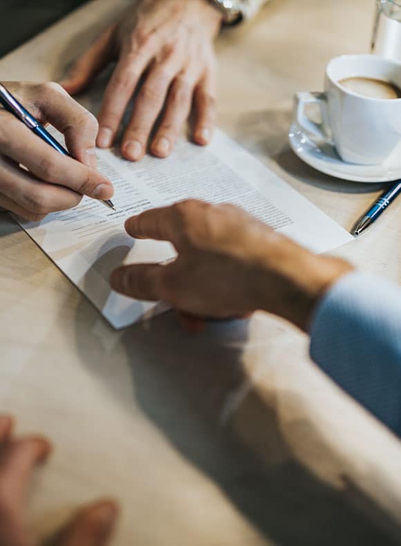 Person indicating where to sign a document