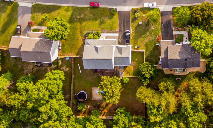 Aerial view of three homes