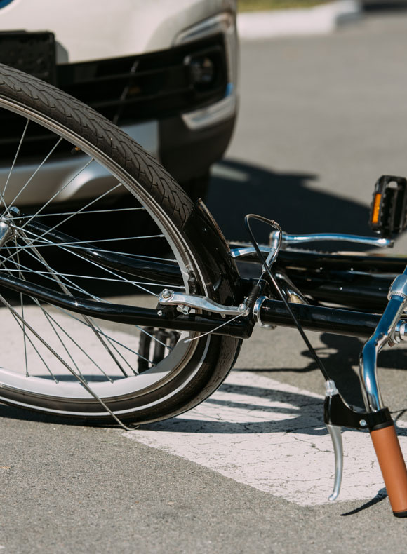 Closeup of Bike Laying on the Ground In Front of a Car